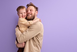 positive caucasian father and son hugging, shine with happiness