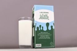 Concept for lab grown milk from artificial cultured dairy production by using reproduced milk proteins. Carton with made up label and drinking glass