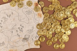 Hand drawn pirate treasure map with toy gold coins for children