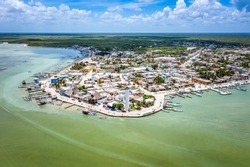 Aerial landscape overlooking the city of Rio Lagartos. The city is surrounded by a beautiful river with azure water. Fishing boats are moored to the shore. Yucatan, Mexico