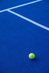 Paddle tennis ball on a blue paddle tennis court. Racket sports