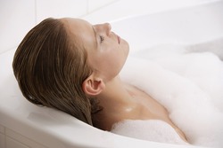 Profile of woman reclining in bath tub