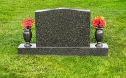 Single blank tombstone with flowers