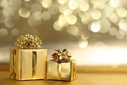 Golden gift boxes on abstract background