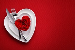 Red rose on white dish.Meal on Valentines Day