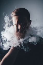 Young man with smoke in front of head