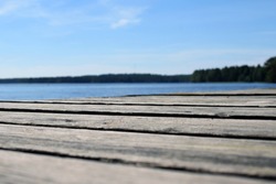 Low angle view of wooden pier. Lake on background. Shallow depth of field.