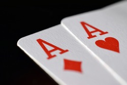 Pair of aces on the black table. Close up image with copy space.