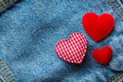 Valentine's Day. jeans background with red heart.