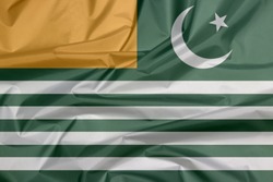 Fabric flag of Azad Kashmir state flag. Green background with four white stripes; a gold canton and a star and crescent.