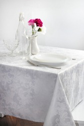 
a table with a white tablecloth reservation for one person
