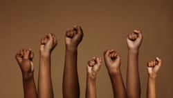 Cropped shot of hands raised with closed fists. Multiple hands raised up with closed fist symbolizing the black lives matter movement.