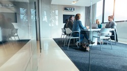 Group of business people having discussion in conference room. Creative business team brainstorming over new project.