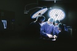 Medical team performing surgery. Group of surgeons in hospital operation theater.