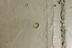 The marks of bullets and shrapnel on Board the armoured military vehicle. Old military relief texture of the tank green color.
