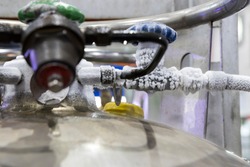 ice at valve and pipe of liquid nitrogen tank ; selective focus