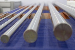 blurred picture of Round stainless steel bars from grinding process ; industrial engineering background