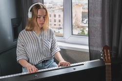 Music.girl plays  piano. Music background, creates music, a soundtrack. Business hobbies, relaxation and psychology. Education and remote work music making. AI-Generated 