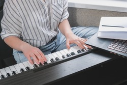 Music.girl plays piano. Music background, creates music, a soundtrack. Business hobbies, relaxation and psychology. Education and remote work music making. AI-Generated 