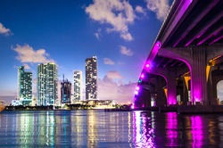Bayside Marketplace shot from under the Venetian Causeway bridge, which is illuminated in pink