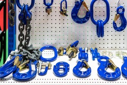 various type of metal or steel lifting hook chain and accessories such as master link shackle screw pin hammerlock connector for hoist crane in industrial place or store on shelf