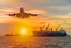 Commercial passenger airplane fly over a large general cargo ship sailing in the sea near the coast and spread the wheel prepare landing to airport in evening while golden sunset