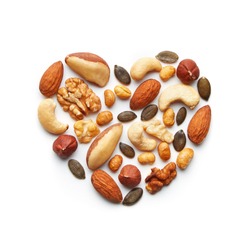 Various nuts arranged in a heart shape. Almond, peanut, brazil nut, pumpkin seed, sunflower seed, cashew, hazelnut, walnut assortment. Healthy lifestyle concept. Top view
