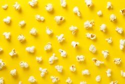 Popcorn pattern on yellow background. Top view