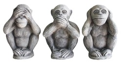 Three monkey isolated on white background,close up of hand small statues with the concept of see no evil, hear no evil and speak no evil.