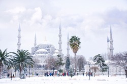 The blue mosque (Sultanahmet mosque) in winter day with snow in Istanbul,Turkey. Tourist group walk around Turkish landmarks.