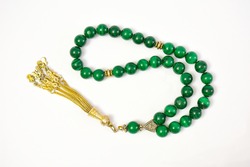 Malachite material prayer beads (rosary) on white background. 