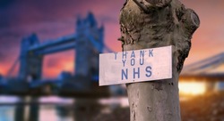 Thank you NHS sign with London sunset city blurred background during coronavirus pandemic in the UK