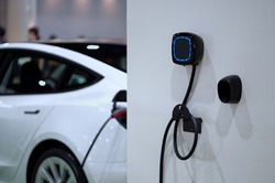 Wall mounted electric charger in the home garage.