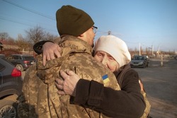 Elderly mother says goodbye to her military son. Mom hugs a Ukrainian soldier. Militarization. Ukrainian defender says goodbye to his family. Mobilization of Ukrainian men. War of Ukraine and Russia