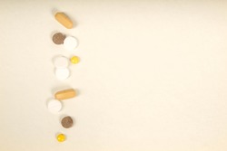 Multi-colored tablets and pills. On white background.top view