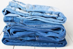 Jeans on a light background. Detail of nice blue jeans. Jeans texture or denim background.