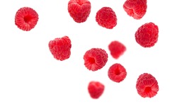 Flying raspberries isolated on white background. Sweet ripe fresh delicious raspberry, summer berry, organic food, vitamins. Creative background with falling raspberry fruits