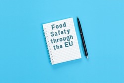 The text Food safety through the EU. Concept photo signifying the EU's food safety policy covers food from farm to fork.