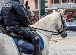 German Policeman in uniform riding a horse