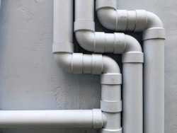 Drain pipe on gray building's wall