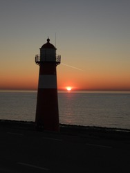 amazing sunset in Netherlands with a lighthouse