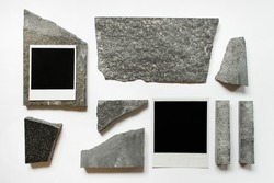Abstract composition with two polaroid cards and random sized stones on white background.