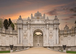 Sunset shot of closed gate leading to former Ottoman Dolmabahce Palace, or Dolmabahce Sarayi, suited in Ciragan Street, Besiktas district, Istanbul, Turkey. View from the internal court