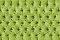 Green capitone checkered soft fabric textile decorative background with buttons. Classic retro Chesterfield style, luxurious upholstery buttoned texture for furniture, wall, headboard, sofa, couch