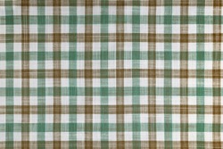 Green and brown checkered texture fabric, tartan pattern. Shirt fabric, tablecloth textile, linen plaid cloth, classic scottish check pattern. Backdrop, wallpaper, background.