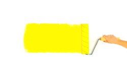 painter painted a roller bright yellow strip on the wall, isolated on a white background