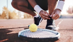 Tennis player tying sport shoes. Sport, recreation concept