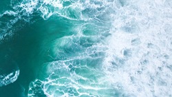 Aerial view to tropical beach and wave blue ocean at New Zealand. Aerial drone shot of turquoise sea water at the beach - space for text. 