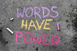 Colorful chalk drawing on asphalt: text WORDS HAVE POWER