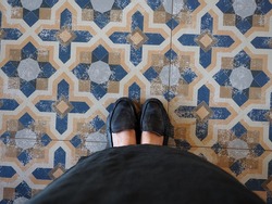 Black shoes on the antique tiles 